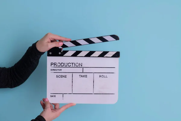 Movie clapper on cyan background — Stock Photo, Image