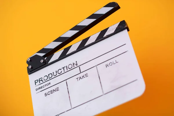 movie clapper on yellow background