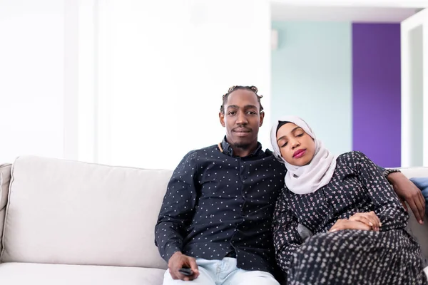 African Couple Sitting On Sofa Watching TV Together — Stock Photo, Image