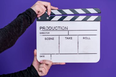 movie clapper on purple violet background clipart