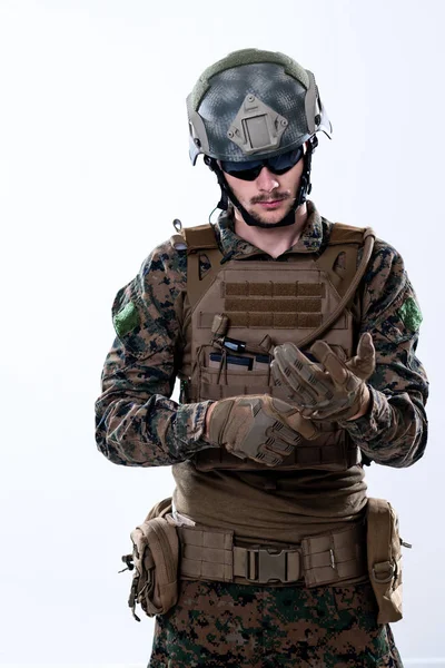 Closeup of soldier hands putting protective battle gloves — Stock Photo, Image