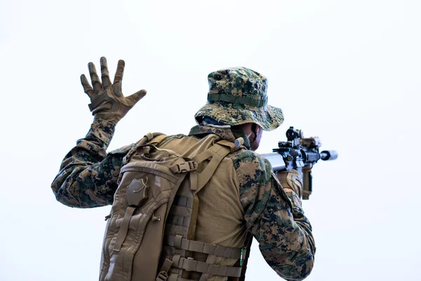 Soldier in action giving comands to team by hand sign — Stock Photo, Image