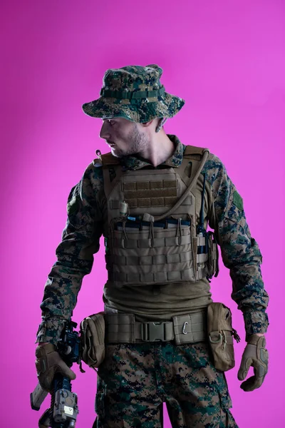 Modern warfare soldier pink backgorund — Stock Photo, Image