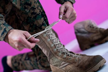 soldier tying the laces on his boots