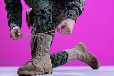 soldier tying the laces on his boots