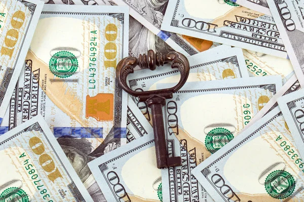 Old key on money background — Stock Photo, Image