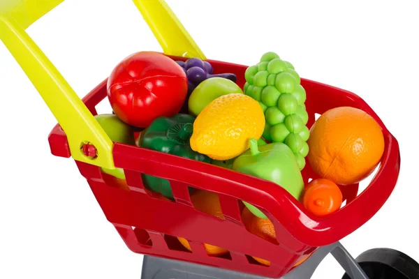 Carrinho de compras de brinquedo cheio de frutas — Fotografia de Stock