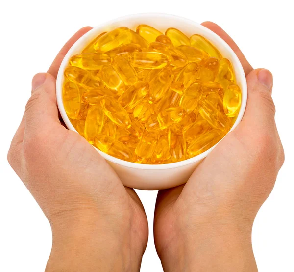 Ciotola piena di omega 3 capsule in mano — Foto Stock