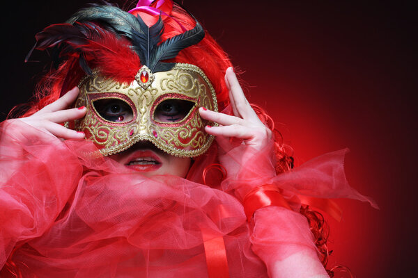 Beautiful redhair woman with mask. Carnaval visage.
