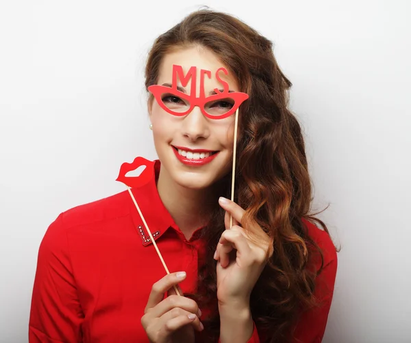 Playful young woman holding a party glasses. — Stock Photo, Image