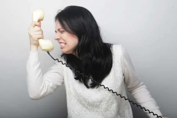 Young happy woman with vintage phone — Stock Photo, Image