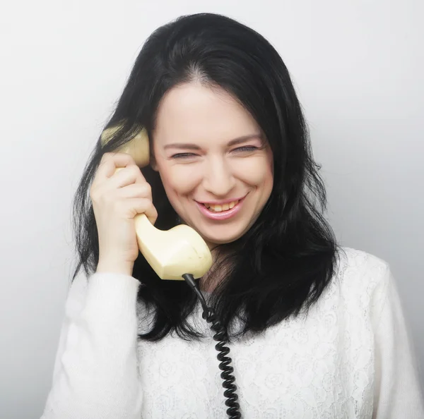 Young happy woman with vintage phone — Stock Photo, Image