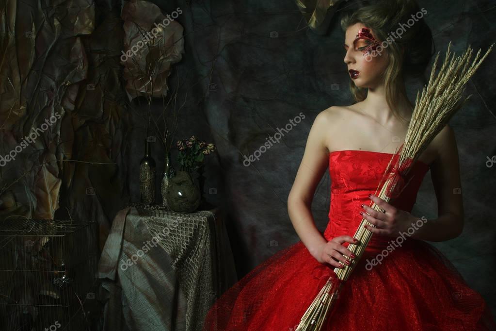 Fashion portrait of romantic beautiful girl with hairstyle, red lips, art dress.Princess in mistery house. Creative concept Once upon a time in fantasy.