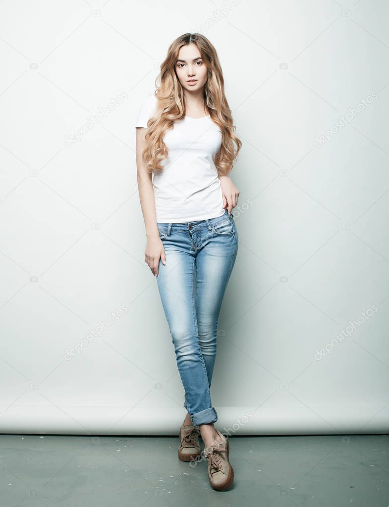 lifestyle, fashion  and people concept: Full body young fashion woman model posing in studio
