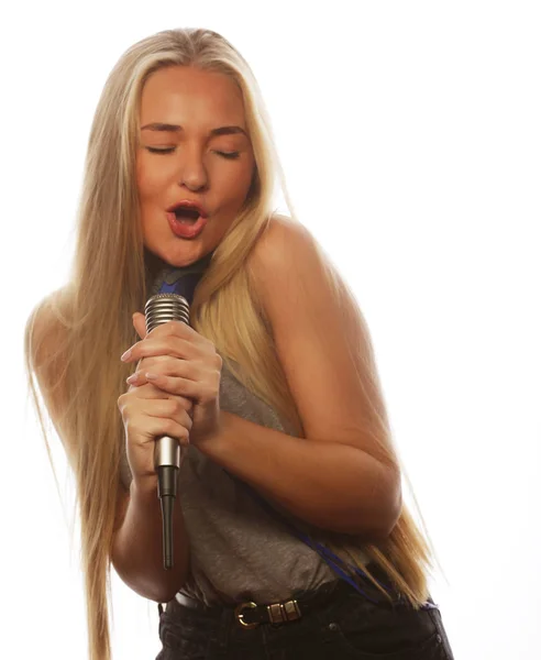 Girl  with a microphone singing and having fun — Stock Photo, Image