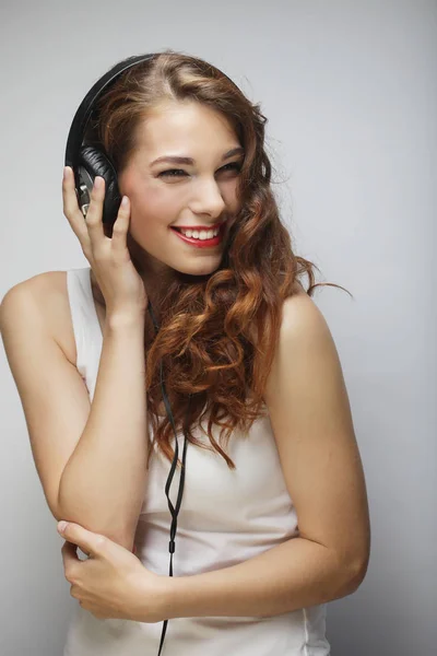 Jeune femme avec écouteurs écouter de la musique — Photo