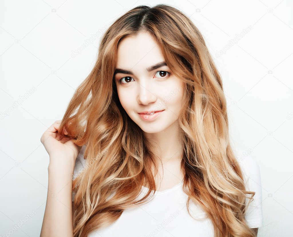 lifestyle and people concept: Young casual woman portrait. Clean face, curly hair.
