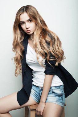 Yaşam tarzı, moda ve insan konsepti: güzel kadın günlük kıyafetler giyiyor, beyaz arka planda poz veriyor.