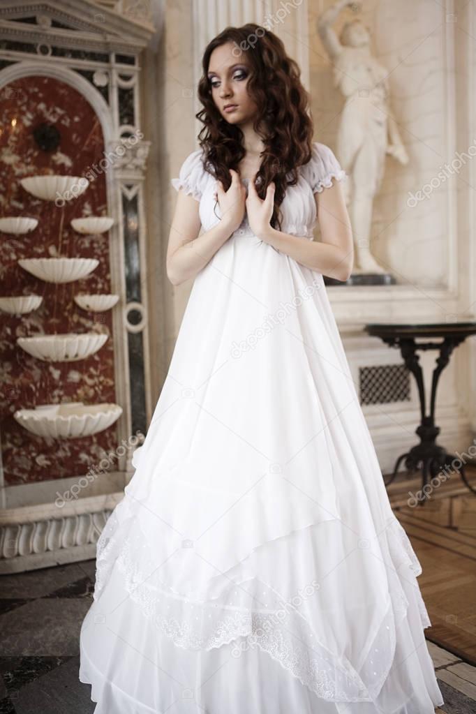 Portrait of a beautiful young victorian lady in white dress