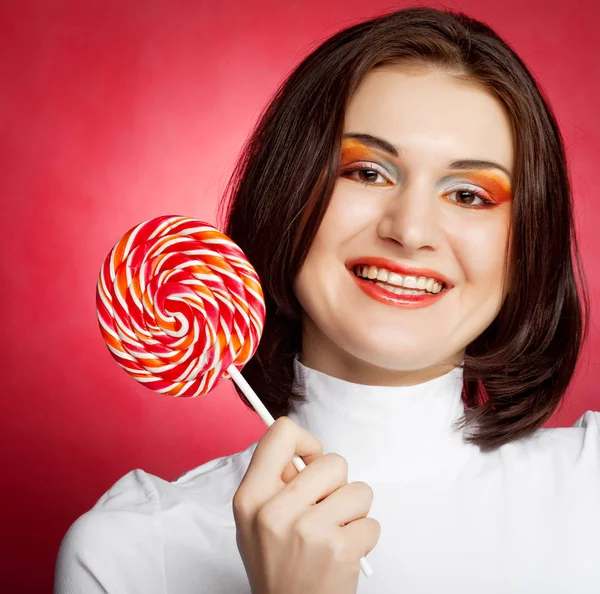 Portrait of young woman with lollipop — Stock Photo, Image