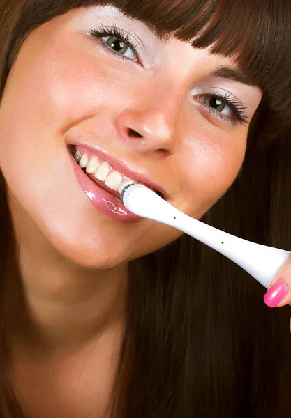 Young beautiful smiling woman with great white teeth holding a t