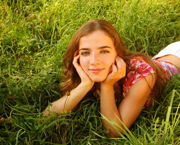 Молода красива дівчина лежить на траві — стокове фото