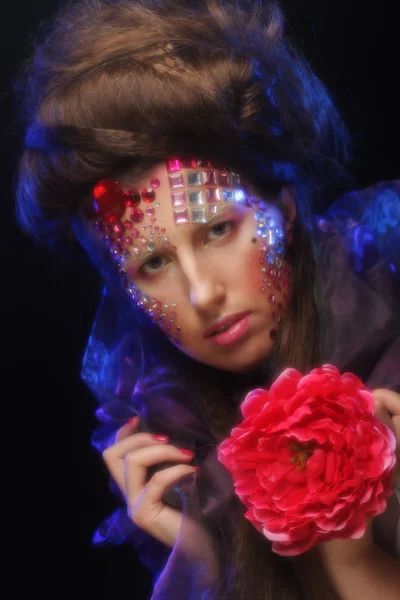 Mujer joven con rostro artístico sosteniendo gran flor roja —  Fotos de Stock