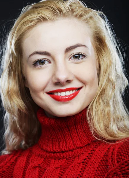 Smiling blonde in red sweater — Stock Photo, Image