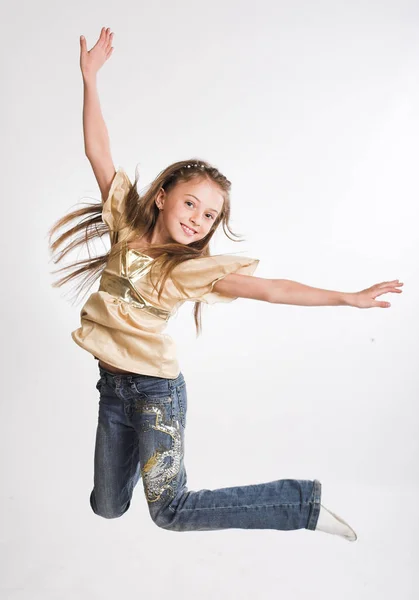 Little girl jump over white background — Stock Photo, Image