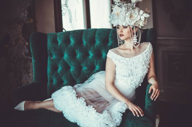 Güzel gelin bir sandalyeye oturur. Lüks Sarayı.