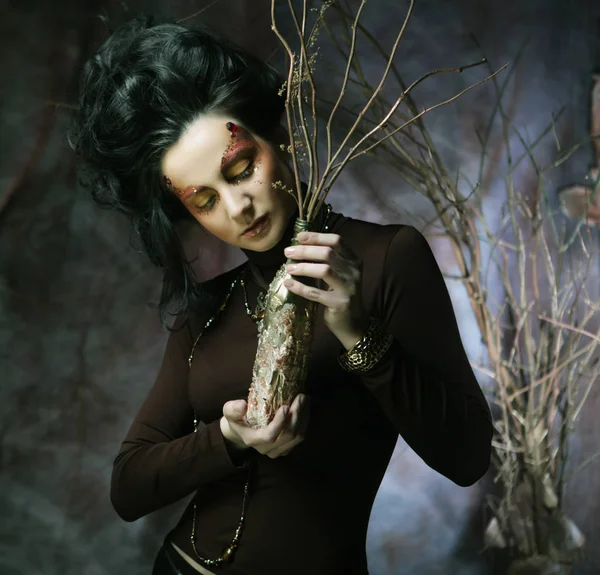 Young woman with bright make up with dry branches — Stock Photo, Image