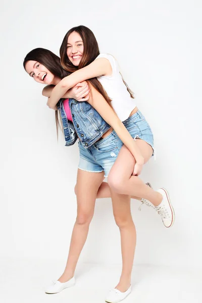 Full body portrait of two hipster girls over white background — Stock Photo, Image