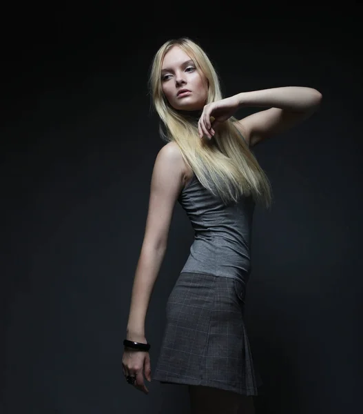 Portrait of beautiful young blonde girl in black dress. — Stock Photo, Image