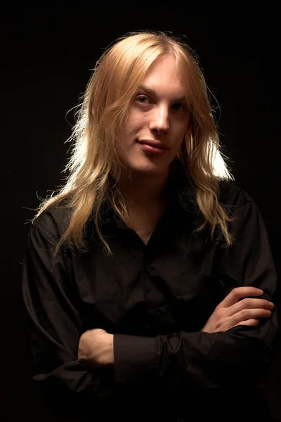 Young man with long blond hair Stock Photo