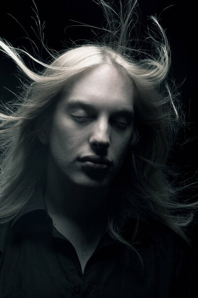 Young man with long blond hair