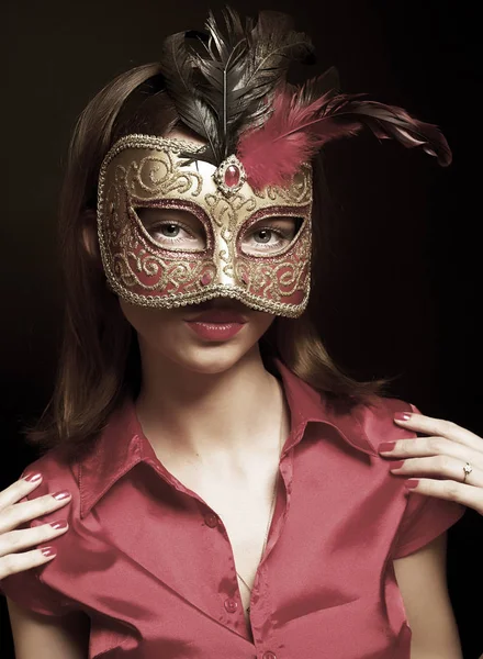 Beautiful young woman wearing red cold carnival mask — Stock Photo, Image