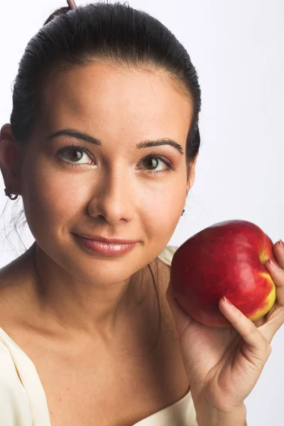 Pretty young smiling woman with red apple. — Stock Photo, Image
