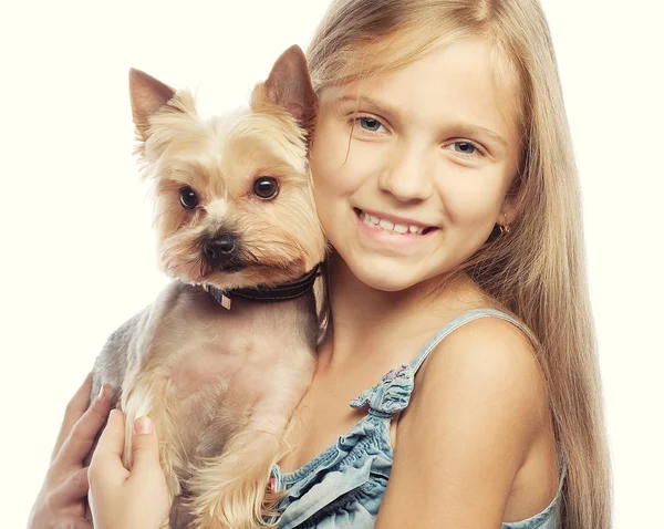 Portrait of an adorable young girl smiling holding a cute puppy — Stock Photo, Image