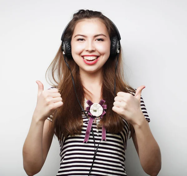 Woman with headphones listening music. Music girl dancing agains — Stock Photo, Image