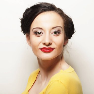 Beyaz arka planda gülümseyen güzel esmer kız.