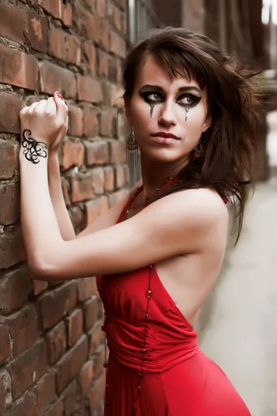 Girl in red gown with face-art — Stock Photo, Image