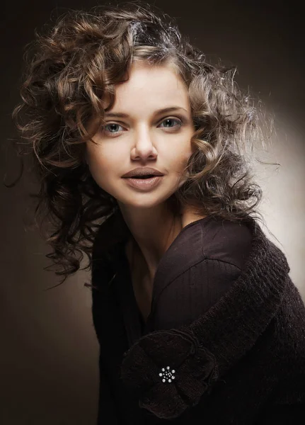 Beautiful young woman with curly hair — Stock Photo, Image