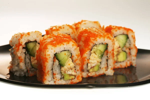 Rollos japoneses en plato negro . — Foto de Stock