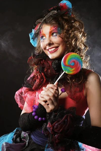 Woman with creative make-up in doll style with candy. — Stock Photo, Image