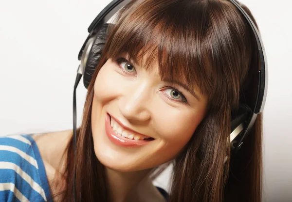 Livsstil och människor koncept: ung kvinna med hörlurar lyssna — Stockfoto