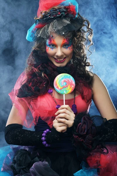 Woman with creative make-up in doll style with candy. — Stock Photo, Image