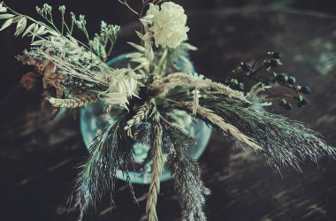 Masanın üzerinde kurumuş çiçekler var.