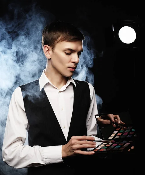 Professional makeup artist posing in studio, holds a palette of — Stock Photo, Image