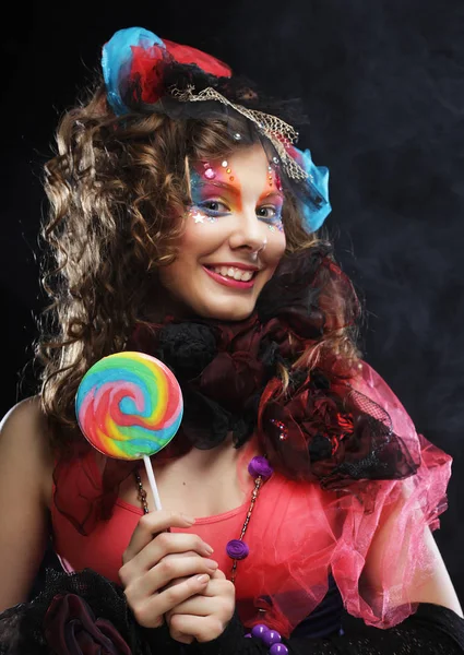 Woman with creative make-up in doll style with candy. — Stock Photo, Image