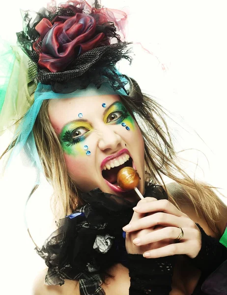 Menina com com maquiagem criativa detém pirulito. — Fotografia de Stock
